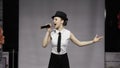 Beautiful girl black hat cute sing song mic elegant movecatwalk. Woman sing mic Royalty Free Stock Photo