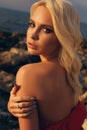 Beautiful girl with blond hair in bikini posing at sunset beach Royalty Free Stock Photo