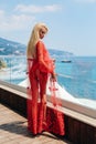 Beautiful girl with blond hair in elegant swimming suit  and accessories posing near open air swimming pool Royalty Free Stock Photo