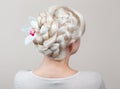 Beautiful girl with blonde hair, hairdresser weaves a braid close-up Royalty Free Stock Photo