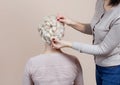 Beautiful girl with blonde hair, hairdresser weaves a braid close-up, in a beauty salon. Royalty Free Stock Photo