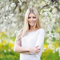 Beautiful girl in blooming tree in spring Royalty Free Stock Photo