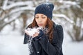 Beautiful girl blowing snow off her hands. Outdoor winter portrait Royalty Free Stock Photo