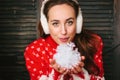 Beautiful girl blowing to the snow in hands during christmas celebration - christmas and new year concept Royalty Free Stock Photo