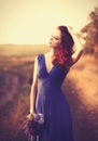 Beautiful girl in blue dress with bouquet