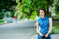 Beautiful girl in blue dress in the crosshairs with purse Royalty Free Stock Photo