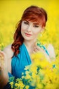 Beautiful girl in blue dress with yellow flowers Royalty Free Stock Photo