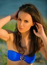 Beautiful girl in blue swimsuit posing on the beach Royalty Free Stock Photo