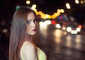 Beautiful girl on blurred carlights background with copyspace Royalty Free Stock Photo