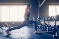 Beautiful girl doing lunges exercise with dumbbells in gym Royalty Free Stock Photo