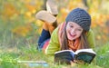 Beautiful girl with book in autumn park