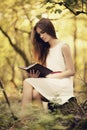 Beautiful girl with book in the forest Royalty Free Stock Photo