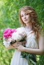 Beautiful girl with a bouquet of peonies in hands Royalty Free Stock Photo