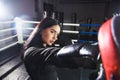 Beautiful girl boxer is standing on the ground with the opponent. Fight in the boxing ring