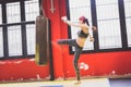 Beautiful girl boxing against punching bag (intentionally blurred) Royalty Free Stock Photo