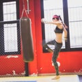 Beautiful girl boxing against punching bag (intentionally blurred) Royalty Free Stock Photo