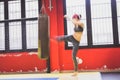 Beautiful girl boxing against punching bag (intentionally blurred) Royalty Free Stock Photo