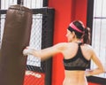 Beautiful girl boxing against punching bag (intentionally blurred) Royalty Free Stock Photo