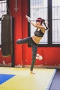 Beautiful girl boxing against punching bag Royalty Free Stock Photo