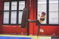 Beautiful girl boxing against punching bag Royalty Free Stock Photo