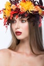 Beautiful girl with bright autumn wreath of