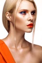 Beautiful girl with bright colored makeup and orange lips. Beauty face. Royalty Free Stock Photo