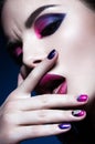 Beautiful girl with bright creative fashion makeup and colorful nail polish. Art beauty design. Royalty Free Stock Photo