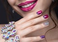 Beautiful girl with a bright evening make-up and pink manicure with rhinestones. Nail design. Beauty face. Royalty Free Stock Photo