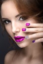 Beautiful girl with a bright evening make-up and purple manicure with rhinestones. Nail design. Beauty face. Royalty Free Stock Photo