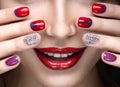 Beautiful girl with a bright evening make-up and red manicure with rhinestones. Nail design. Beauty face. Royalty Free Stock Photo