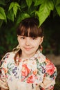 A beautiful girl in a bright raincoat walks during the rain under an umbrella. Soft focus Royalty Free Stock Photo