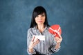 Beautiful girl, brunette opens the box as a heart, a gift. Valentine`s Day, hand and heart proposal, marriage, love Royalty Free Stock Photo