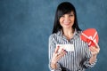 Beautiful girl, brunette opens the box as a heart, a gift. Valentine`s Day, hand and heart proposal, marriage, love, space for Royalty Free Stock Photo