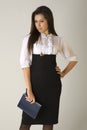 Beautiful girl in business outfit holding agenda