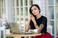 Beautiful girl businesswoman working on laptop in cafe, female freelancer
