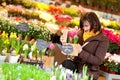 Beautiful girl buying flowers at flower market