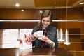 Beautiful girl in cafe opens and joyfully looks in a white g Royalty Free Stock Photo