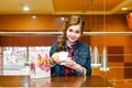 Beautiful girl in the cafe opens white gift box Royalty Free Stock Photo