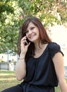 Beautiful girl call by phone in a park