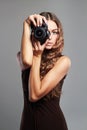 Beautiful girl with camera.Pretty woman is a professional photographer