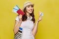 A beautiful girl in casual clothes is holding a passport and airline tickets with credit bank cards Royalty Free Stock Photo