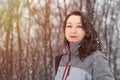 Beautiful girl in casual clothes in winter snowy day