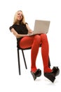 Beautiful girl in chair with laptop Royalty Free Stock Photo