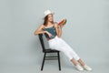 Beautiful girl on chair with watermelon against grey background Royalty Free Stock Photo