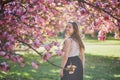 Beautiful girl in cherry blossom garden on a spring day