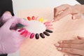 Beautiful girl choose color of nail polishes