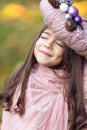 Beautiful girl with a Christmas wreath in pink as a hat