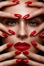 Beautiful girl with a classic make-up and red nails. Manicure design. Beauty face. Royalty Free Stock Photo