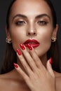 Beautiful girl with a classic make-up and red nails. Manicure design. Beauty face. Royalty Free Stock Photo