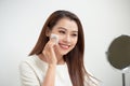 Beautiful girl cleans the face of makeup with a cotton pad Royalty Free Stock Photo